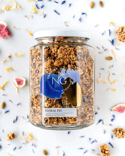Glass jar of chunky granola with ingredients on the background