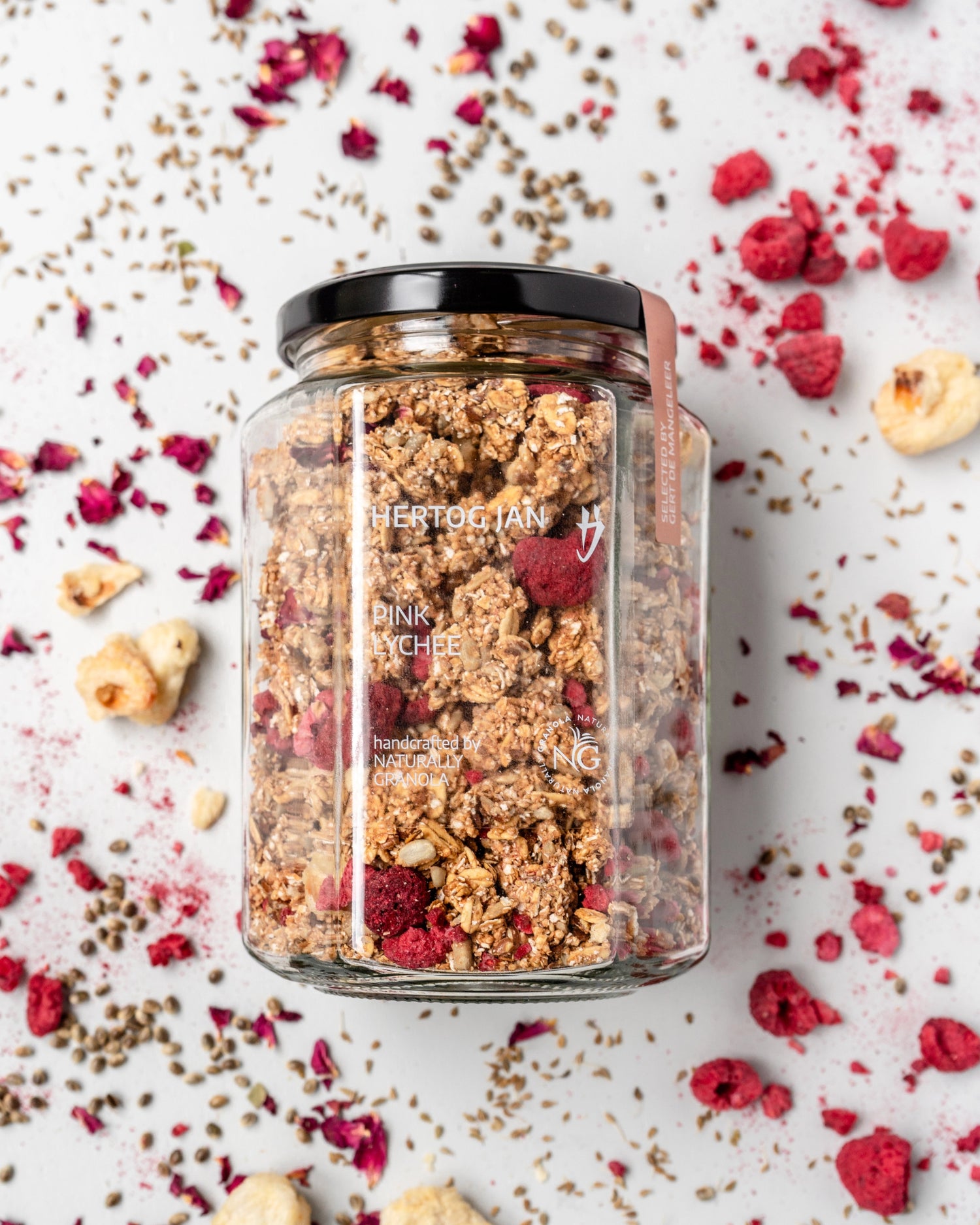 pink-lychee-granola in jar with ingredients in background. Collaboration with 3 star michelin chef gert de mangeleer