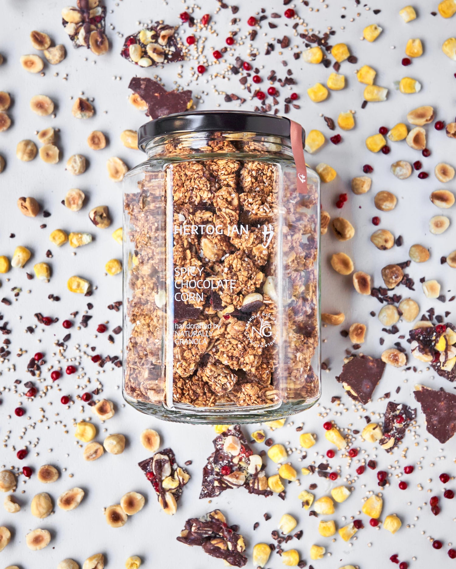 Spicy Chocolate Corn granola in jar, made with belgian chocolate and michelin star chef with ingredients in the background